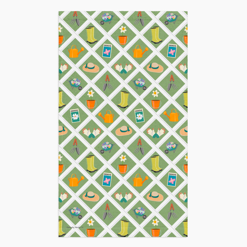 Cloth kitchen hand towel with green garden-themed pattern on a white background