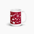 A white ceramic mug featuring a festive deep red wraparound print with white holiday silhouettes, including snowflakes, trees, Santa hats, sleighs, and reindeer shown against a light grey background.