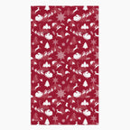 A rectangular deep red hand towel featuring a repeating white Christmas pattern with Santa Claus, sleighs, trees, snowflakes, and winter motifs, shown on a light gray background.
