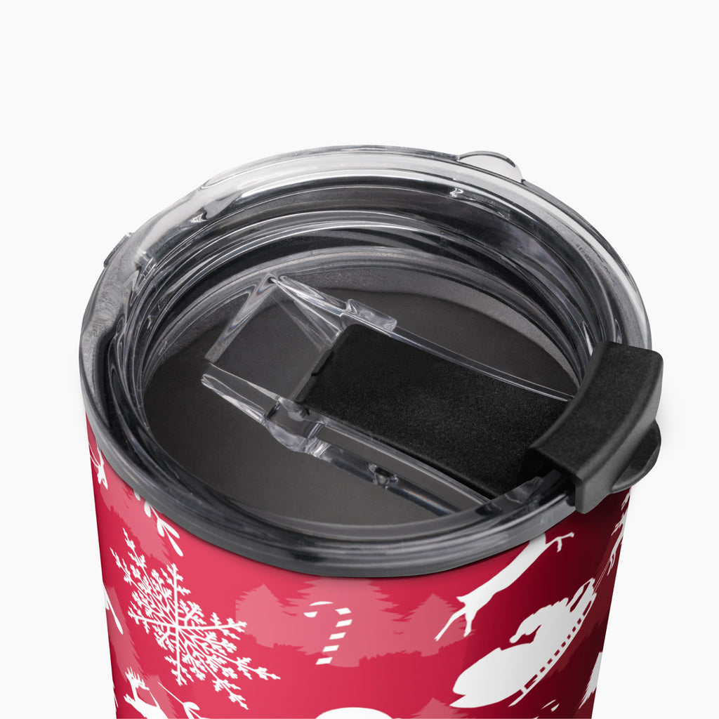 Close-up of a deep red insulated tumbler with a clear lid and black flip cover, decorated with white holiday snowflakes and silhouettes, on a light gray background.