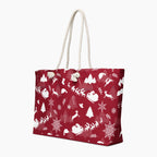 A deep red tote bag with a white Christmas-themed pattern featuring Santa Claus, reindeer, snowflakes, and trees, complete with two cream rope handles.