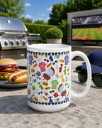 White mug with Dad-themed graphics on a patio with food and outdoor furniture at a backyard BBQ.