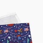 Close-up corned of cloth napkins with a colorful pattern of patriotic-symbol-themed illustrations on a white background.