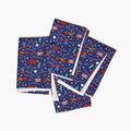 Four folded cloth napkins with a colorful pattern of patriotic-symbol-themed illustrations on a white background.