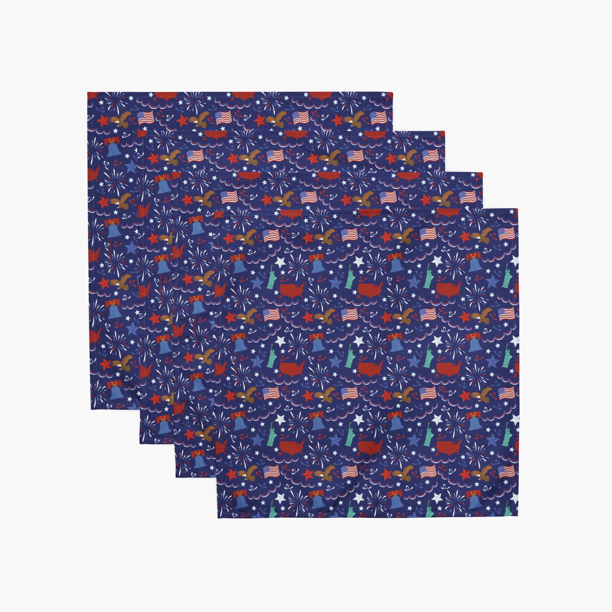Four cloth napkins with a colorful pattern of patriotic-symbol-themed illustrations on a white background.