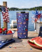 Custom printed patriotic tumbler on a wooden dock with berries, watermelon, and American flag decorations.