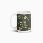 A white ceramic mug with a dark green pumpkin spice-themed pattern featuring pumpkins, leaves, coffee cups, and small illustrations, shown on a light gray background.