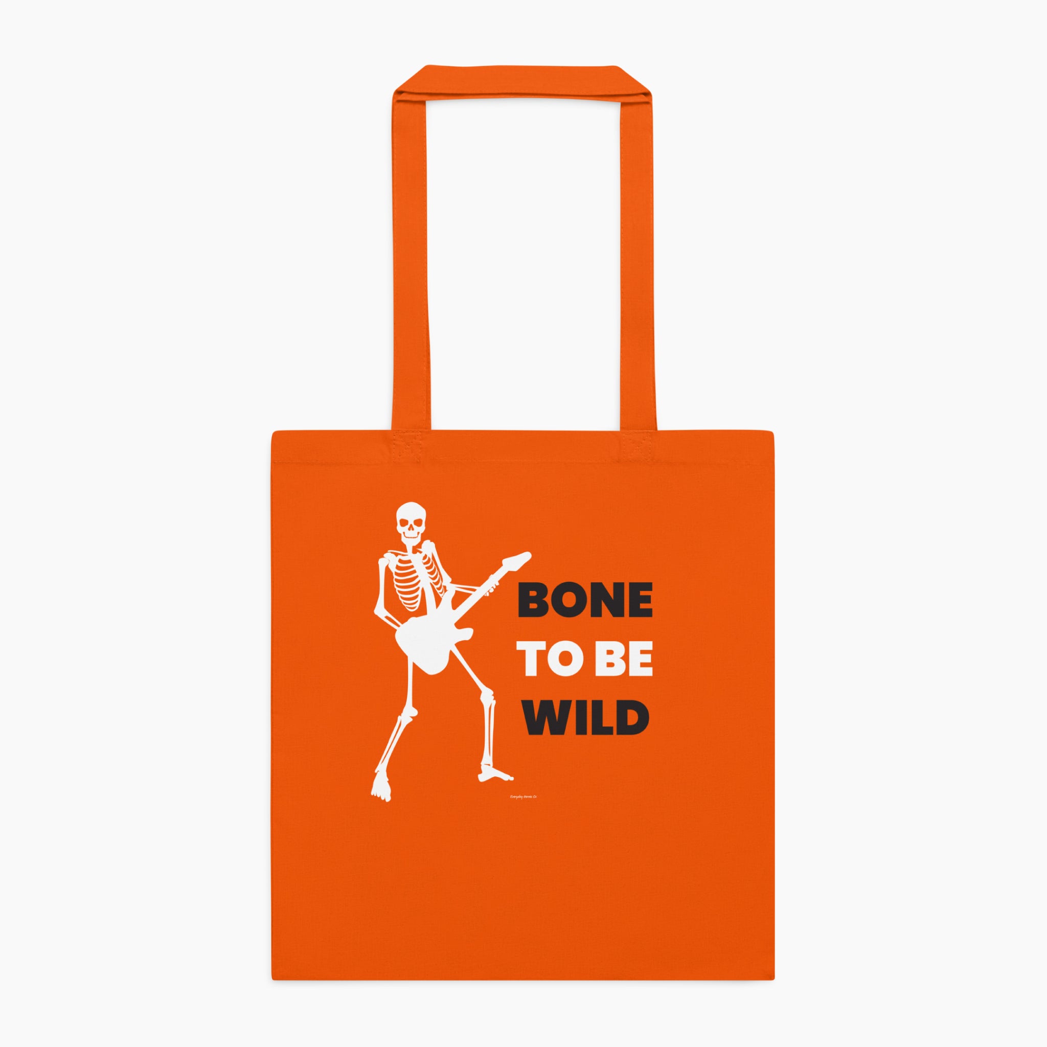 An orange canvas tote bag with two top handles, featuring a white graphic of a skeleton playing an electric guitar next to the text 'BONE TO BE WILD' in white and black lettering staged flat against a light grey background.