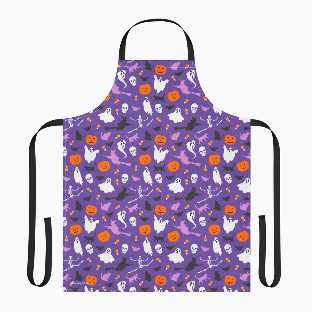 A purple apron with a black neck loop and waist ties, featuring an all-over Halloween pattern of orange pumpkins, white ghosts, black cats, and witches on a light gray background.
