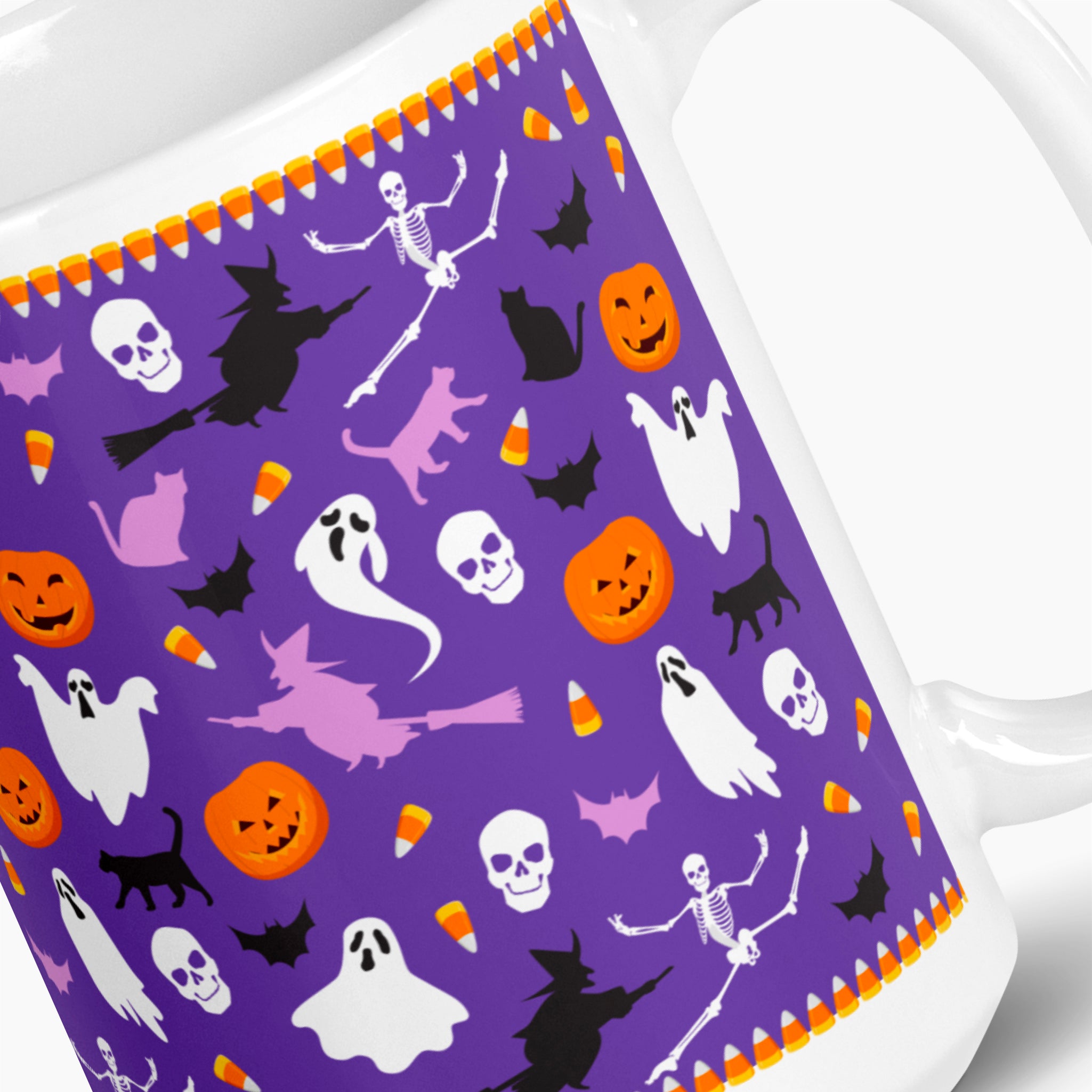 A close-up of a white ceramic mug featuring a vibrant purple Halloween-themed wrap design with cartoon skeletons, ghosts, pumpkins, witches, and candy corn.