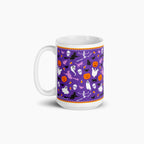 A white ceramic mug featuring a purple Halloween-themed pattern with ghosts, pumpkins, bats, skeletons, candy corn, and witches shown on a light gray background.
