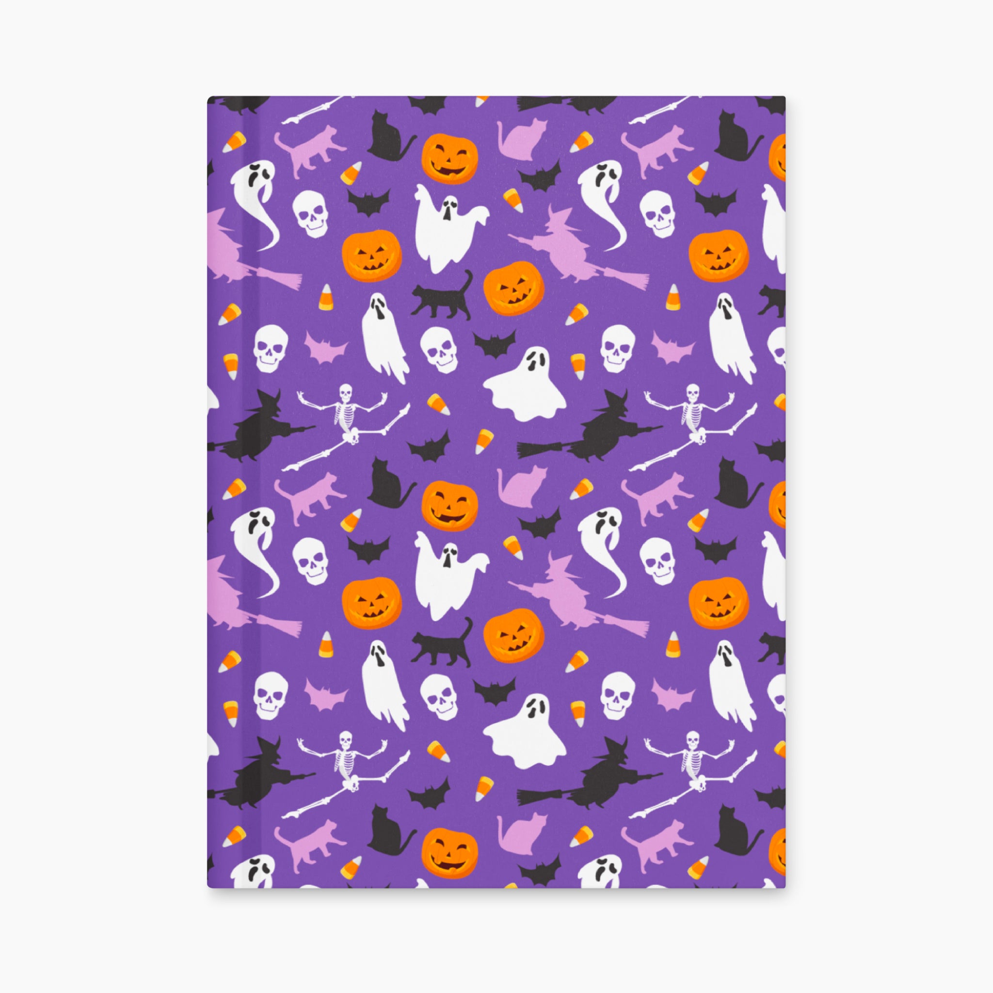A notebook with a purple cover decorated with a Halloween pattern of ghosts, pumpkins, bats, and cats, shown flat upright against a light gray background.