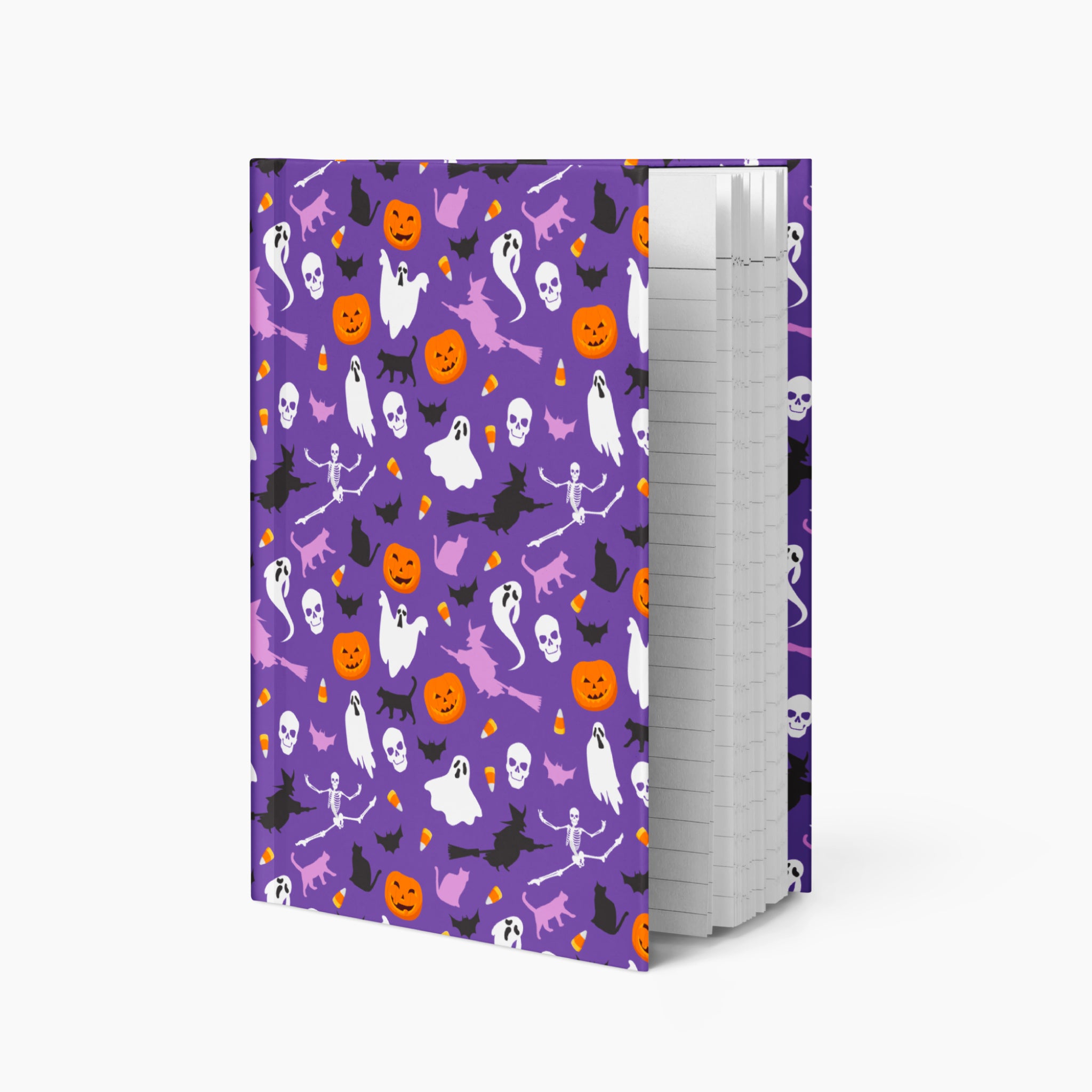 A notebook with a purple cover decorated with a Halloween pattern of ghosts, pumpkins, bats, and cats, shown standing upright against a light gray background.