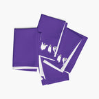 Four purple cloth napkins, featuring a white ghost pattern, arranged on a light gray background.