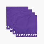 Four purple square napkins stacked in an overlapping fan arrangement on a light gray background. Each napkin has a white line of small ghost silhouettes along the bottom edge.