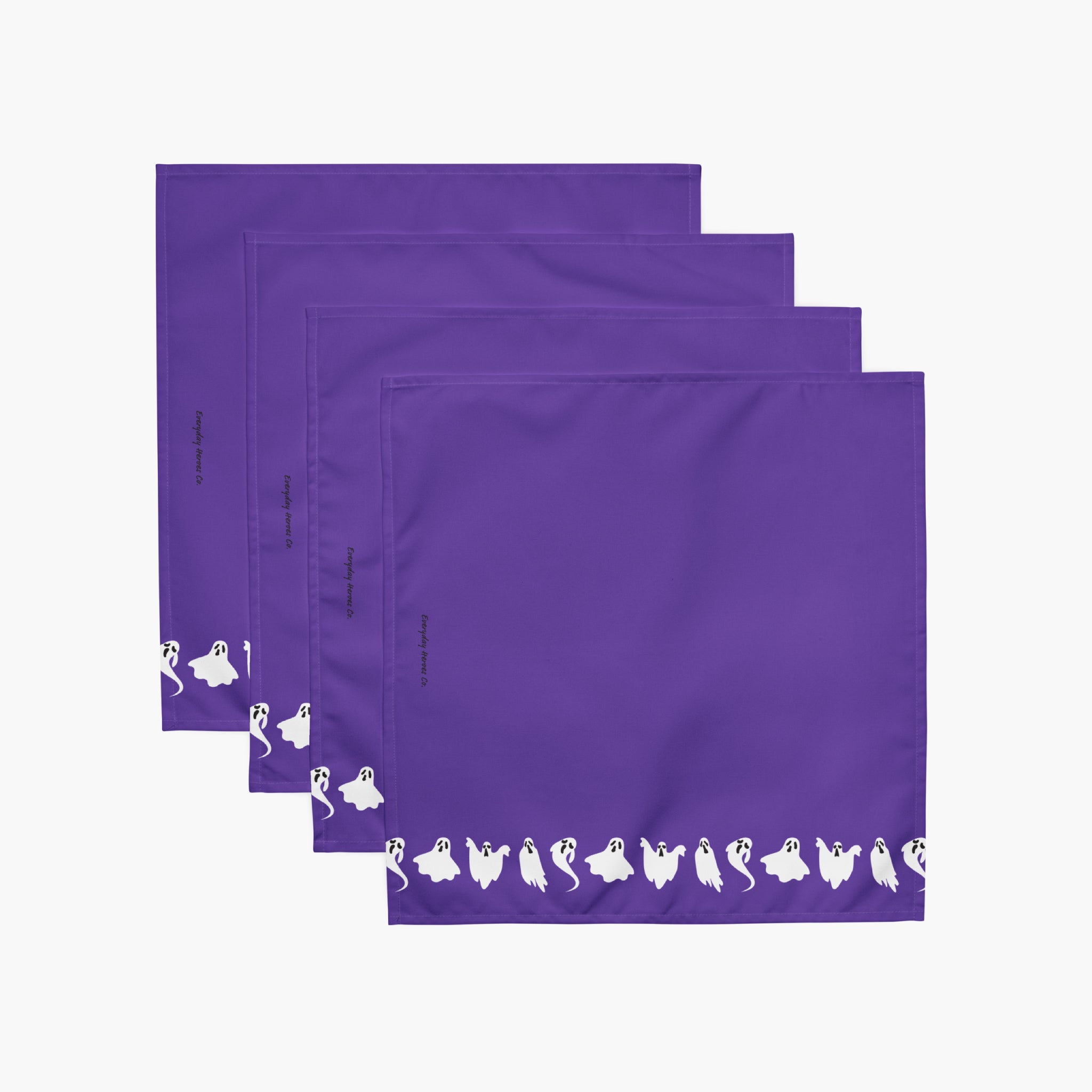 Four purple square napkins stacked in an overlapping fan arrangement on a light gray background. Each napkin has a white line of small ghost silhouettes along the bottom edge.