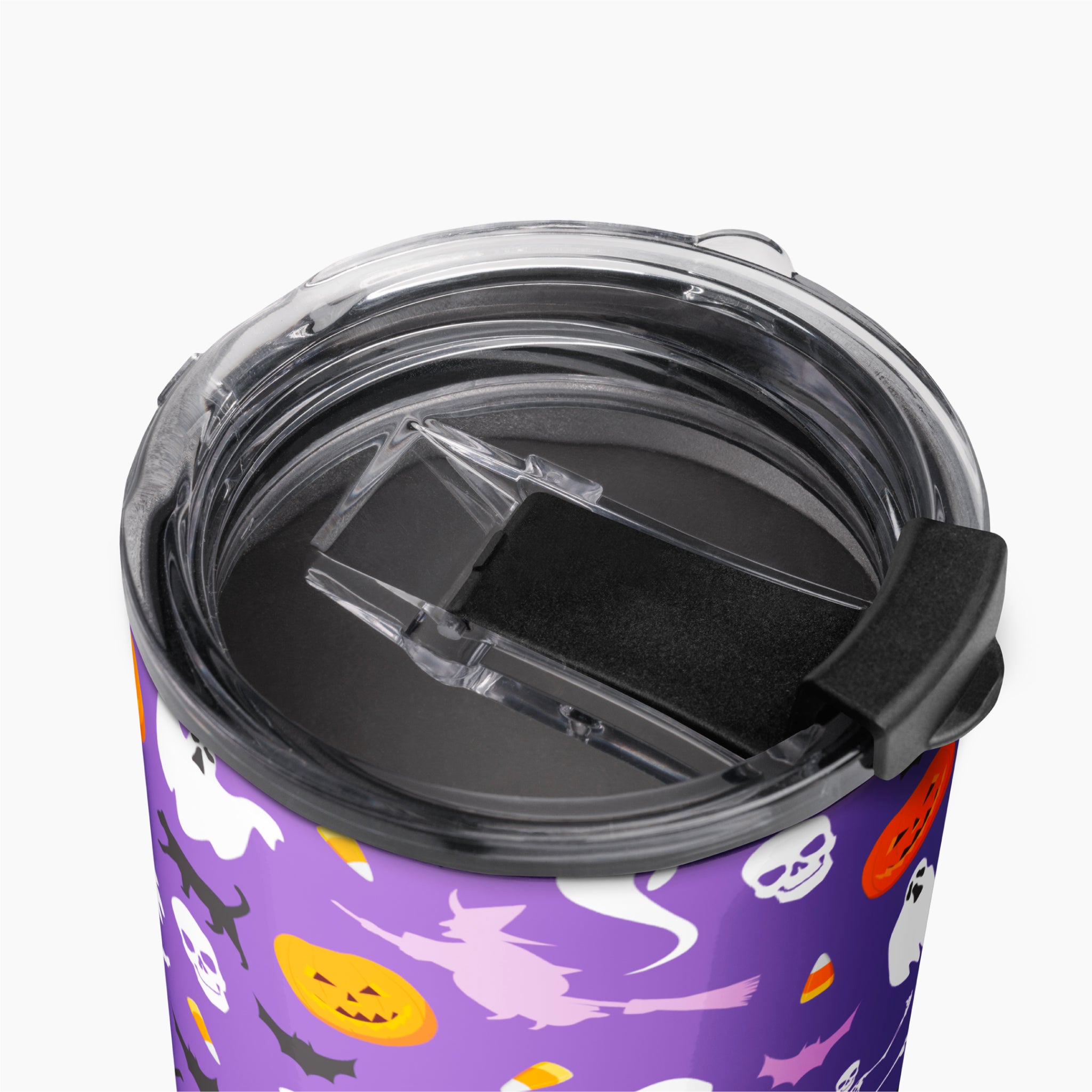 A close-up of a purple tumbler with a Halloween pattern of ghosts, pumpkins, bats, and witches, shown from above with a clear lid and black flip cover.