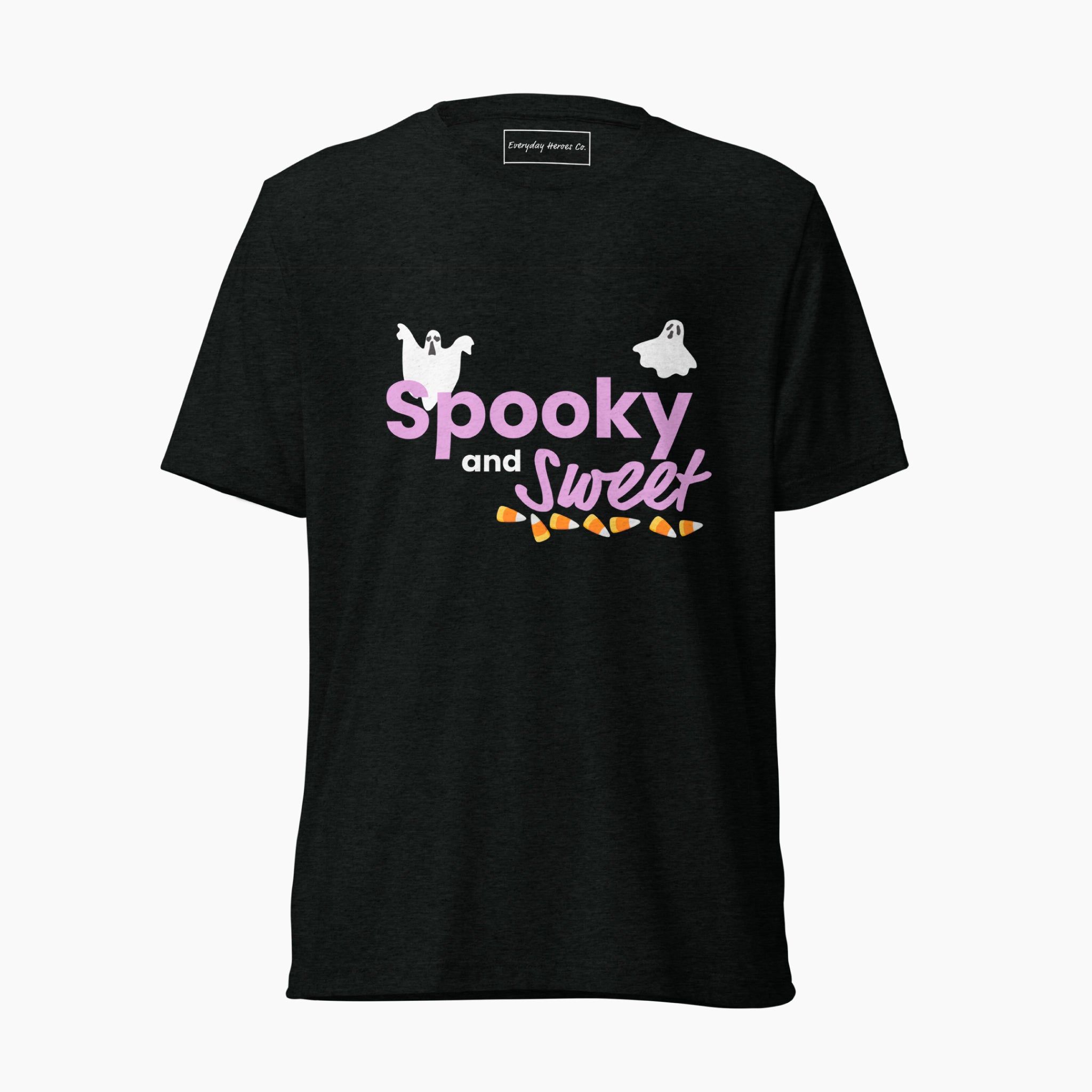 A black short-sleeve t-shirt with purple text that says 'Spooky and Sweet' with decorative halloween graphics, white ghosts and a bottom border on the text of candy corn. The shirt is staged on a plain light grey background.