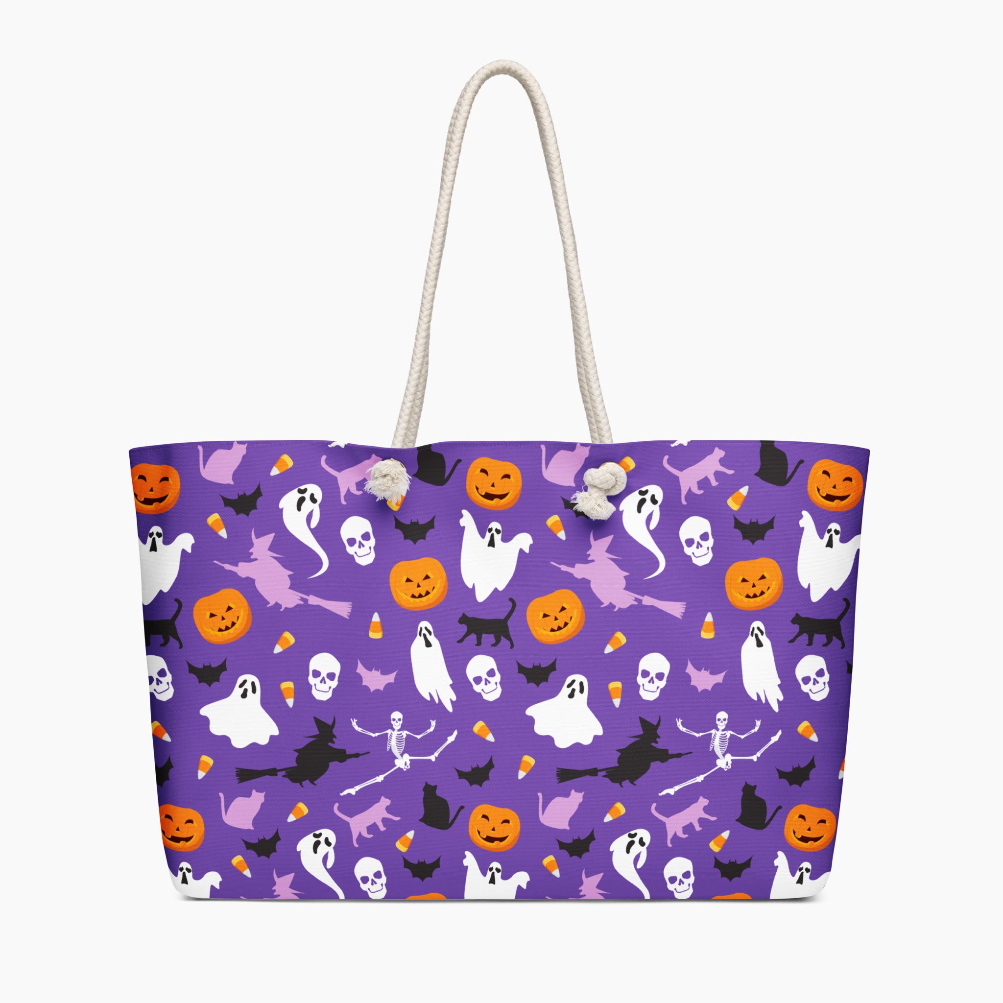 A purple tote bag with a Halloween-themed print featuring ghosts, pumpkins, bats, skeletons, and cats, complete with white rope handles, shown against a plain light-grey background.