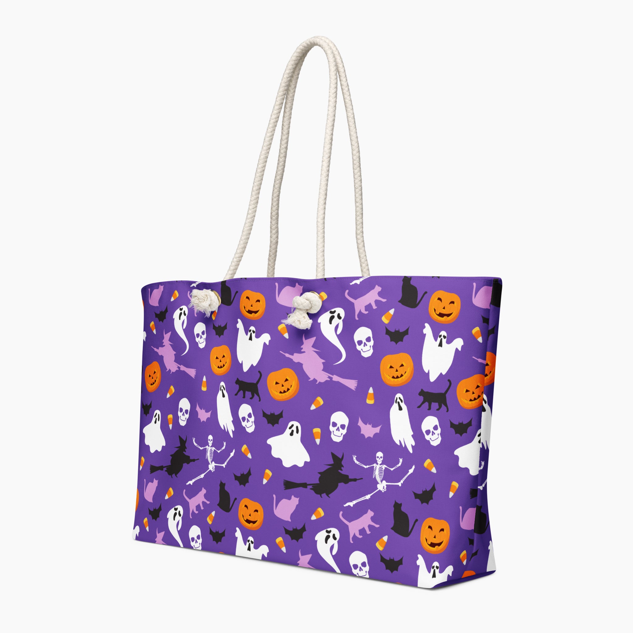 A purple tote bag with a Halloween pattern featuring ghosts, pumpkins, bats, and skeletons, complete with white rope handles, shown on a light gray background.