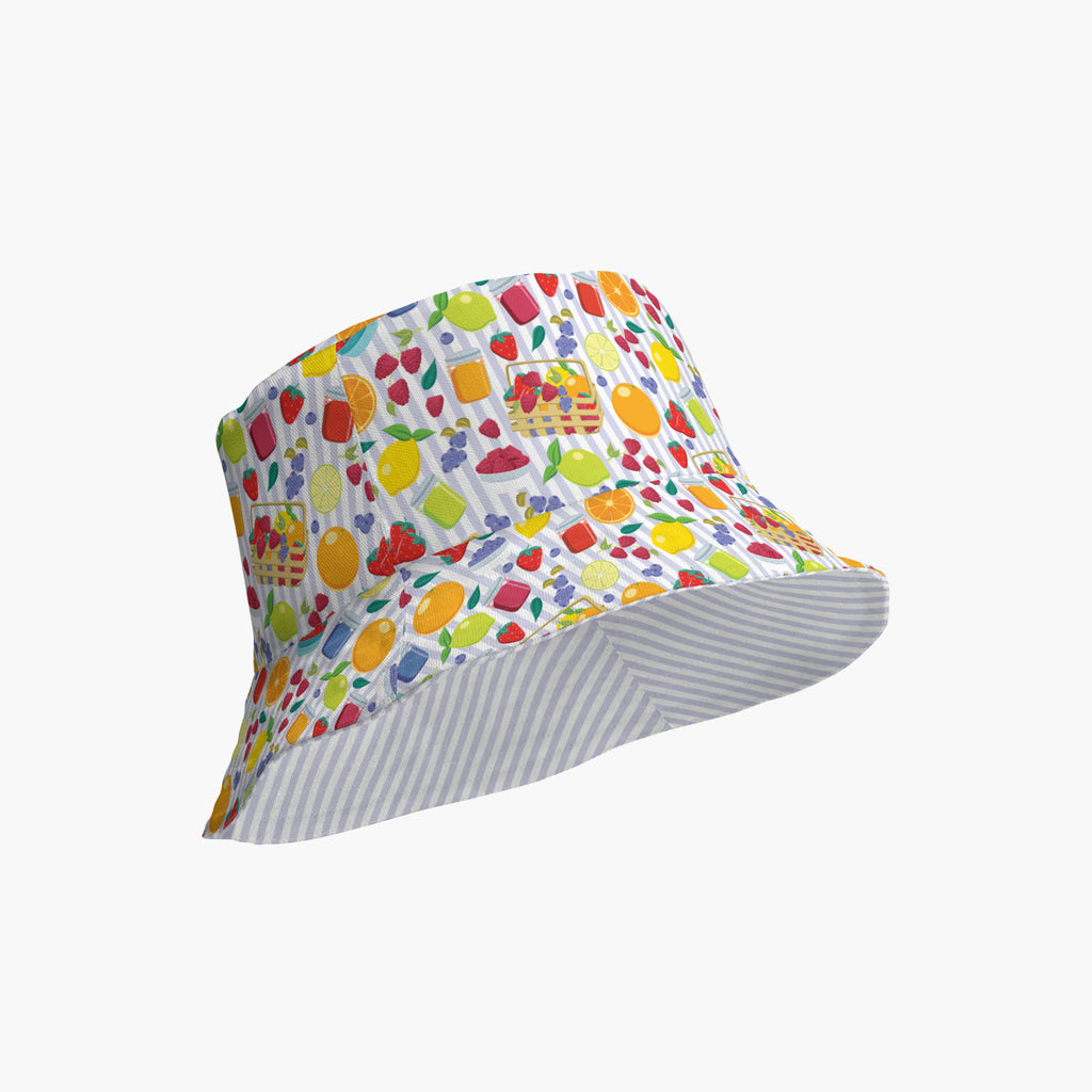 Reversible bucket hat with colorful summer fruit pattern on a white background