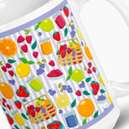 White mug with colorful summer fruit pattern on a white background