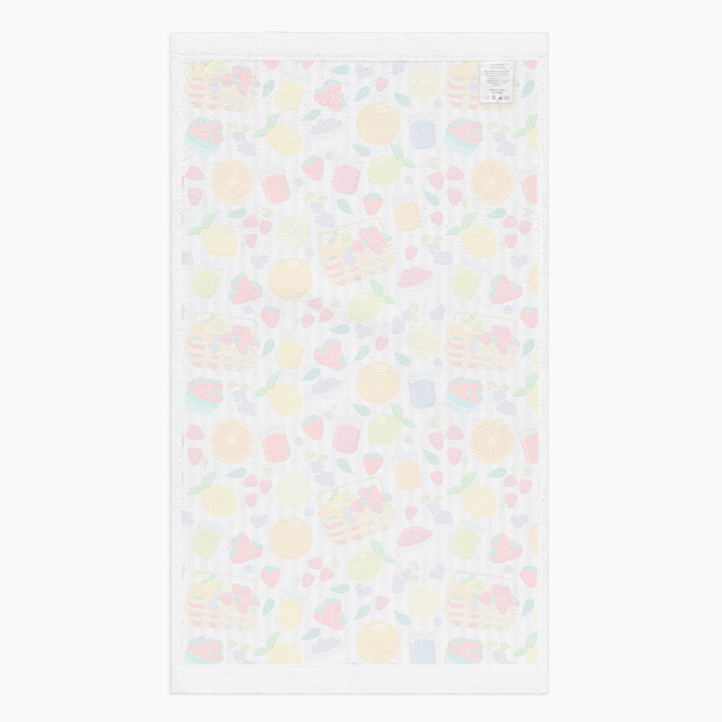 White back of cloth kitchen hand towel with summer fruits pattern on a white background