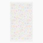 White back of cloth kitchen hand towel with summer fruits pattern on a white background