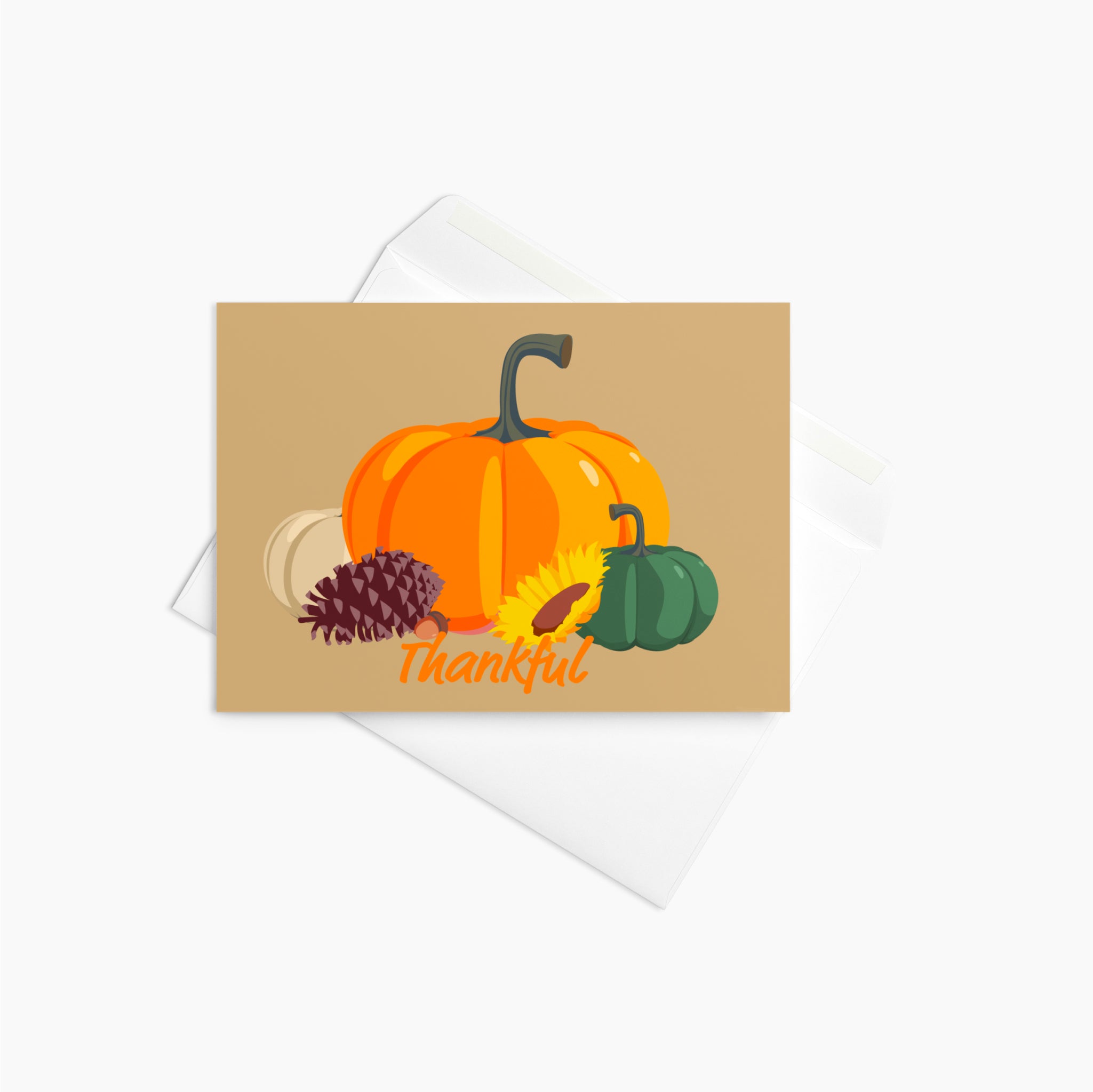 A rectangular autumn-themed greeting card with a tan background and illustrated pumpkins, a pinecone, a sunflower, and the word 'Thankful' in orange script, shown with a white envelope sitting on a light gray background.
