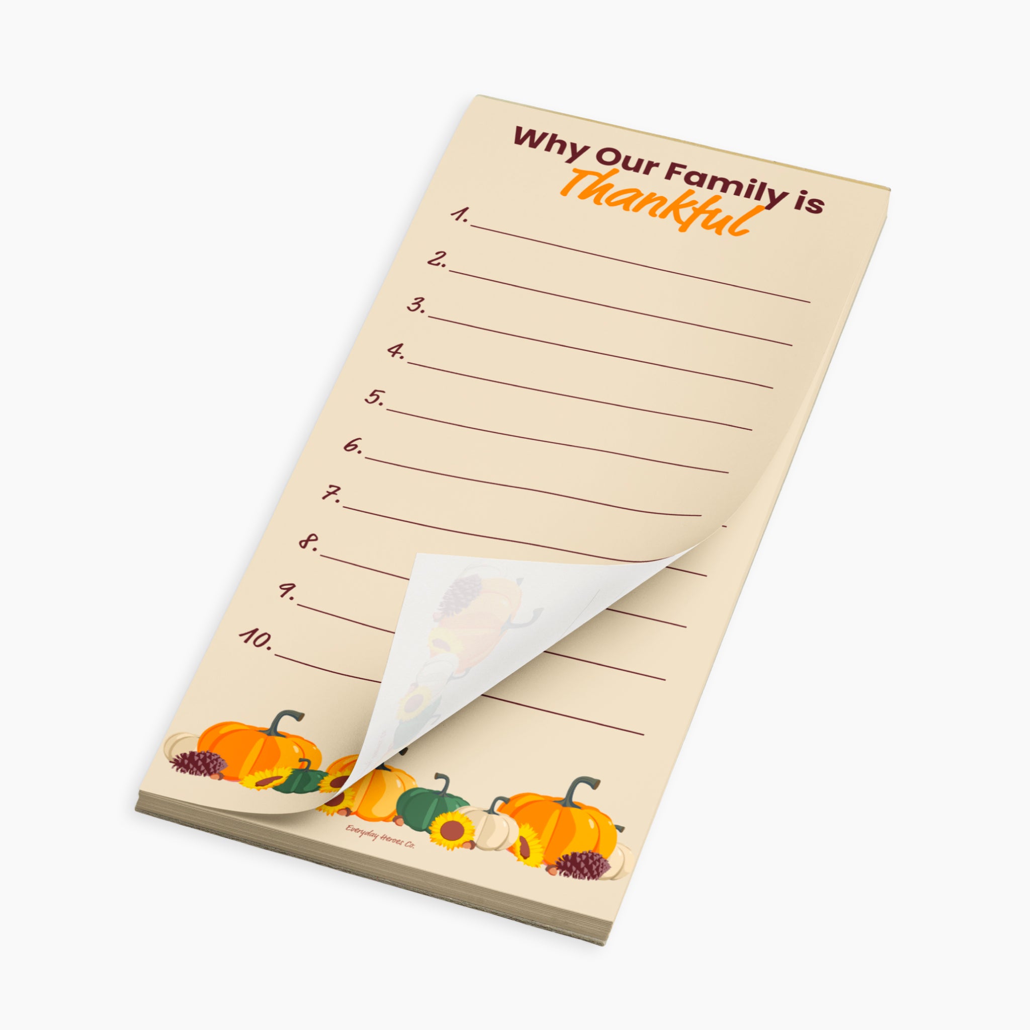 A family reflection notepad with a Thanksgiving theme, featuring the text 'Why Our Family is Thankful' and numbered lines from 1 to 10. The pad has a warm beige background with illustrations of pumpkins and gourds along the bottom edge, and a curled-back bottom-right corner showing the white backing paper.