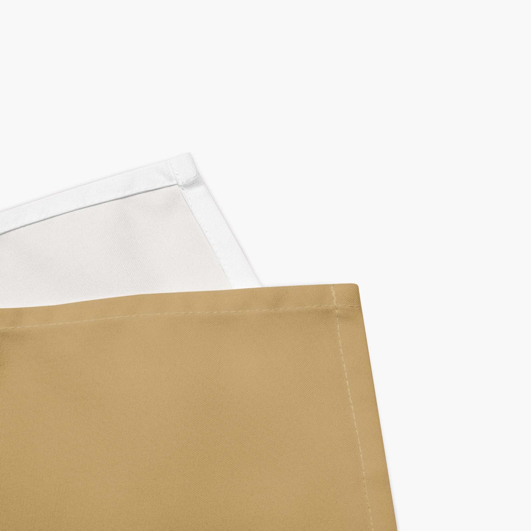 A close-up of a purple cloth napkins, showing its solid tan front and a white reverse side with a stitched edge, set against a plain light grey background.