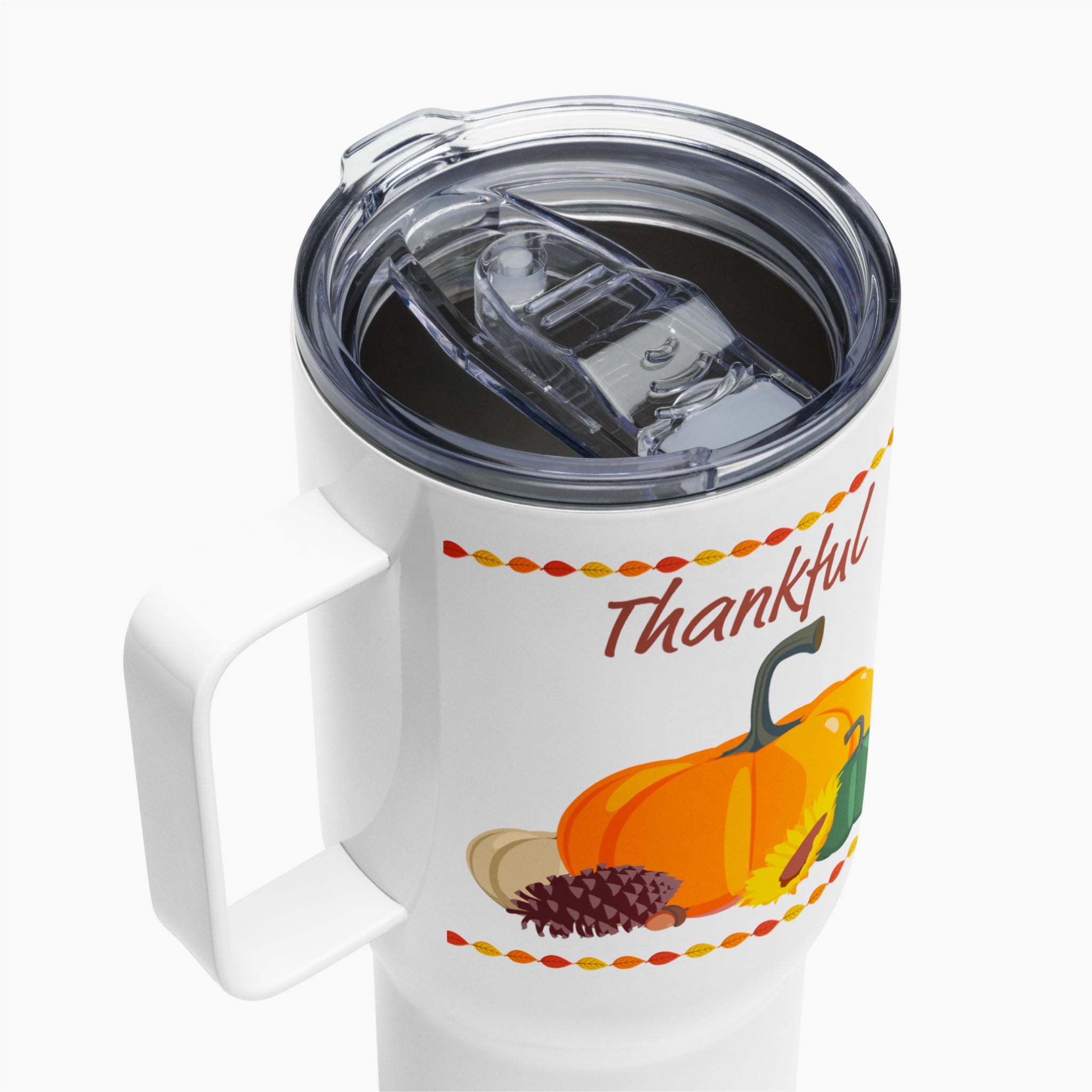 A close-up of a White insulated travel tumbler with a clear lid and handle, featuring a Thanksgiving autumn graphic with pumpkins, a pinecone, acorns, sunflowers, and the word 'Thankful' in brown script.