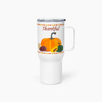 A white insulated travel tumbler with a clear lid and handle, featuring a fall harvest design with the word 'Thankful' above pumpkins, sunflower, and pinecones.