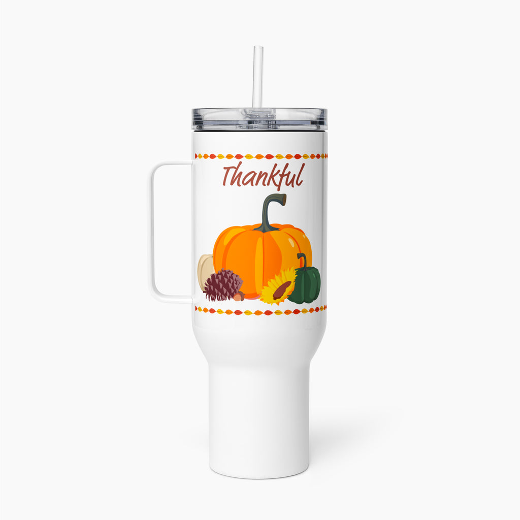 A white insulated travel tumbler with a handle, clear lid, and straw, featuring a fall harvest graphic with the word 'Thankful' above pumpkins, sunflower, pinecone, and acorn.