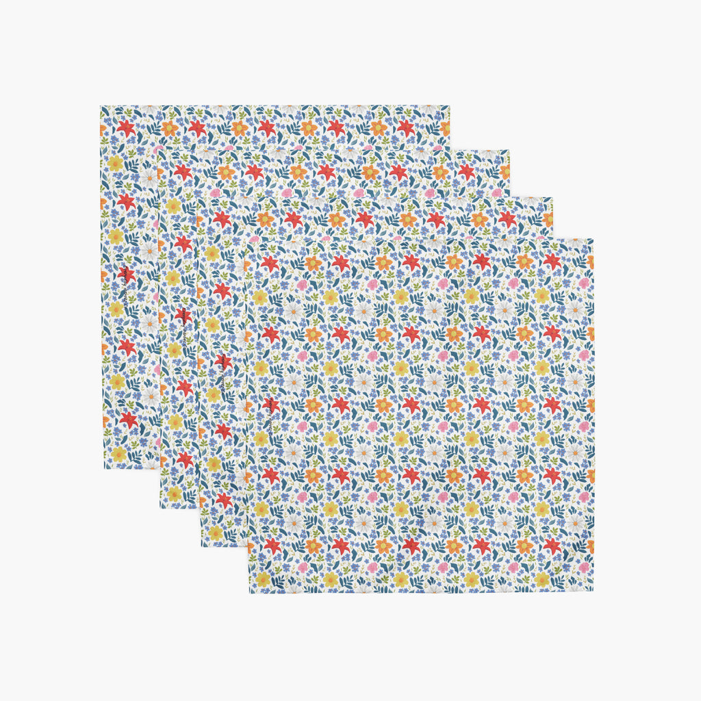 four white floral-patterned cloth napkins on a white background