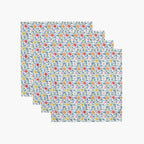 four white floral-patterned cloth napkins on a white background