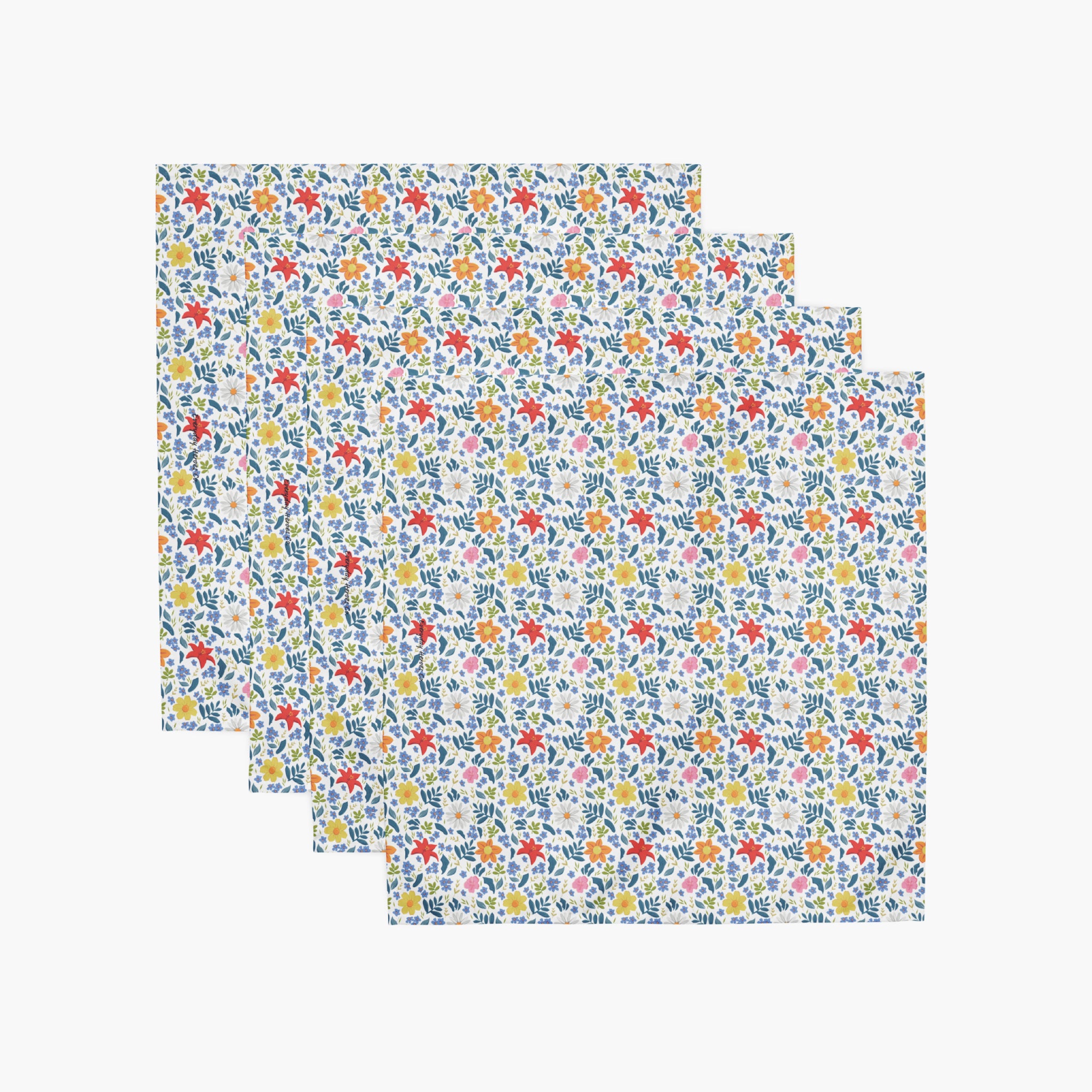 four white floral-patterned cloth napkins on a white background