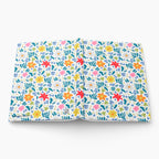 Hardcover journal with white multi floral patterned cover design on a white background