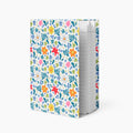 Hardcover journal with white floral patterned cover design and lined pages on a white background