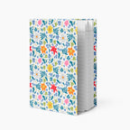 Hardcover journal with white floral patterned cover design and lined pages on a white background