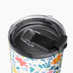 Tumbler with white floral pattern on a white background